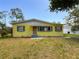 Charming yellow house featuring green shutters and a well-maintained lawn at 5995 59Th N Way, St Petersburg, FL 33709