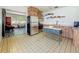 Well-lit kitchen with stainless steel appliances, wooden cabinets, and tile flooring at 5995 59Th N Way, St Petersburg, FL 33709