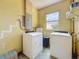 Functional laundry room with washer, dryer, and window to the outside at 5995 59Th N Way, St Petersburg, FL 33709