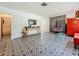 Open living room with unique flooring, a large window, and bright furniture accents at 5995 59Th N Way, St Petersburg, FL 33709