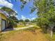 The front yard has mature trees, a circular driveway, and a small lawn at 5995 59Th N Way, St Petersburg, FL 33709