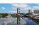 Waterfront high-rise condo with boat docks, surrounded by lush greenery and waterways at 600 Garrison Cove Ln # 2B, Tampa, FL 33602