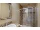 Bathroom featuring a glass shower door, granite countertops, decorative mirror and neutral tiling at 600 Garrison Cove Ln # 2B, Tampa, FL 33602