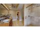 Bathroom featuring granite countertop vanity, glass shower, and access to a water closet at 600 Garrison Cove Ln # 2B, Tampa, FL 33602