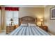 Cozy bedroom featuring a wood headboard, complemented by matching bedside tables with a window at 600 Garrison Cove Ln # 2B, Tampa, FL 33602