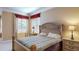 Comfortable bedroom featuring a bed with decorative headboard and matching nightstands under a window at 600 Garrison Cove Ln # 2B, Tampa, FL 33602