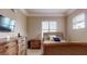 Comfortable bedroom with natural light, neutral colors, and a decorative headboard at 600 Garrison Cove Ln # 2B, Tampa, FL 33602