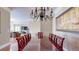 Well-lit dining room featuring hardwood floors, seating for eight, and decorative chandelier at 600 Garrison Cove Ln # 2B, Tampa, FL 33602