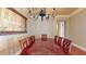 Dining room with seating for eight, hardwood floors, a decorative chandelier, and an adjacent hallway at 600 Garrison Cove Ln # 2B, Tampa, FL 33602