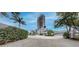Paver driveway leads to a home with a secure entrance, surrounded by lush trees and landscaping at 600 Garrison Cove Ln # 2B, Tampa, FL 33602
