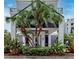 Exterior of a building entrance with mature tropical landscaping and modern architectural details at 600 Garrison Cove Ln # 2B, Tampa, FL 33602