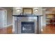 Living room fireplace with custom granite surround, hardwood floors, and white trim at 600 Garrison Cove Ln # 2B, Tampa, FL 33602