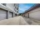 Exterior view of a modern building with garages on either side, under a blue sky at 600 Garrison Cove Ln # 2B, Tampa, FL 33602