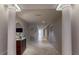 Long hallway with neutral walls, decorative console table, and tiled flooring at 600 Garrison Cove Ln # 2B, Tampa, FL 33602