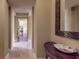 Elegant hallway featuring tiled floors, baseboards, and decorative mirror over a dark wood table at 600 Garrison Cove Ln # 2B, Tampa, FL 33602