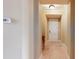 Inviting hallway featuring tiled flooring and neutral paint, leading to the front door at 600 Garrison Cove Ln # 2B, Tampa, FL 33602
