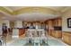 Spacious gourmet kitchen with stone floors, granite countertops, stainless steel appliances, and wooden cabinets at 600 Garrison Cove Ln # 2B, Tampa, FL 33602