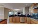 Well-equipped kitchen featuring granite countertops, stainless steel appliances, and open access to the living area at 600 Garrison Cove Ln # 2B, Tampa, FL 33602