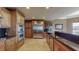 Gourmet kitchen with stainless steel appliances, granite countertops, wooden cabinets, and a large refrigerator at 600 Garrison Cove Ln # 2B, Tampa, FL 33602