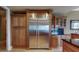 Gourmet kitchen features a stainless steel refrigerator with custom wood cabinetry and granite countertops at 600 Garrison Cove Ln # 2B, Tampa, FL 33602