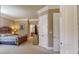 Main bedroom with adjoining bathroom features neutral paint and carpeted floors at 600 Garrison Cove Ln # 2B, Tampa, FL 33602