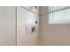 Tiled shower featuring a decorative border and a window with blinds at 600 Garrison Cove Ln # 2B, Tampa, FL 33602