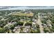 Aerial view of a residential neighborhood with mature trees and a school in the distance at 7313 8Th N Ave, St Petersburg, FL 33710