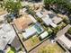 Aerial view features the home's pool, backyard, nearby homes, and lush landscaping at 7313 8Th N Ave, St Petersburg, FL 33710