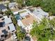 Aerial view of a home featuring a backyard pool, patio, and mature trees at 7313 8Th N Ave, St Petersburg, FL 33710