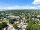 Wide aerial shot of residential area with lush tree cover and glimpse of the waterfront in distance at 7313 8Th N Ave, St Petersburg, FL 33710