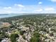 Wide aerial shot capturing residential neighborhood with lush trees and waterfront in the distance at 7313 8Th N Ave, St Petersburg, FL 33710