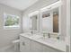 Bright bathroom featuring a double vanity with modern fixtures and quartz countertops at 7313 8Th N Ave, St Petersburg, FL 33710