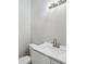 Clean powder room featuring a modern vanity with chrome fixtures, a sleek sink and stylish lighting at 7313 8Th N Ave, St Petersburg, FL 33710