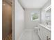 Sleek bathroom showcasing a frameless shower, modern vanity, and bright natural light at 7313 8Th N Ave, St Petersburg, FL 33710