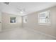 Bright bedroom featuring three windows and light wood-look flooring at 7313 8Th N Ave, St Petersburg, FL 33710