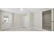 Neutral bedroom with white bi-fold closet and view into the laundry room at 7313 8Th N Ave, St Petersburg, FL 33710