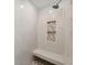 Beautiful shower with pebble floor, built-in bench, and tiled niche for toiletries at 7313 8Th N Ave, St Petersburg, FL 33710