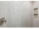Beautiful shower with neutral tile, rainfall shower head, and built-in shelf at 7313 8Th N Ave, St Petersburg, FL 33710