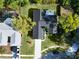 Overhead aerial view of home with dark roof and well-kept backyard with a paved driveway at 7504 Lily Pad Ct, Hudson, FL 34667