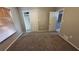 Bedroom with carpet, window with blinds, and direct access to both the closet and ensuite bathroom at 7504 Lily Pad Ct, Hudson, FL 34667