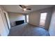 Bedroom with neutral walls, a ceiling fan, a sliding door closet, and two windows for natural light at 7504 Lily Pad Ct, Hudson, FL 34667