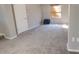 Spacious bedroom with plush carpeting, a window with blinds, and neutral-toned walls at 7504 Lily Pad Ct, Hudson, FL 34667