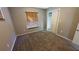 Carpeted bedroom featuring a window with blinds and access to the closet and ensuite bathroom at 7504 Lily Pad Ct, Hudson, FL 34667