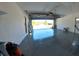 View of the garage featuring epoxy floor, textured walls, open door, and paint supplies at 7504 Lily Pad Ct, Hudson, FL 34667