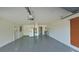Garage with epoxy floor, utility sink, and laundry area with door to outside at 7504 Lily Pad Ct, Hudson, FL 34667