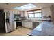 Bright kitchen with white cabinetry, stainless steel appliances, and granite countertops at 7504 Lily Pad Ct, Hudson, FL 34667