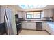 Bright kitchen with white cabinetry, stainless steel appliances, and granite countertops at 7504 Lily Pad Ct, Hudson, FL 34667