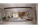 Spacious living room featuring a stone fireplace, beam, and neutral color palette at 7504 Lily Pad Ct, Hudson, FL 34667
