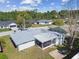 Overhead shot of a single-Gathering home and grassy backyard with patio and screened in back porch at 7553 Sequoia Dr, New Port Richey, FL 34653