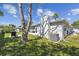 Home exterior highlighting well-maintained lawn, central air conditioning, and outdoor grilling area at 7553 Sequoia Dr, New Port Richey, FL 34653